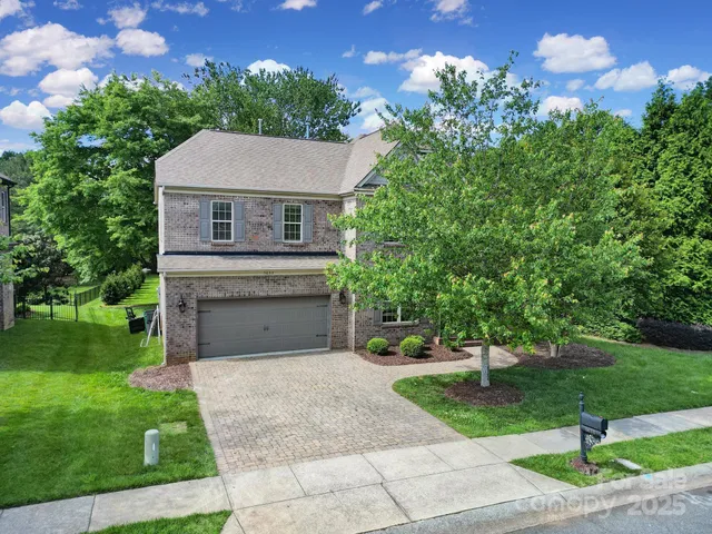 a front view of a house with a yard and a garage