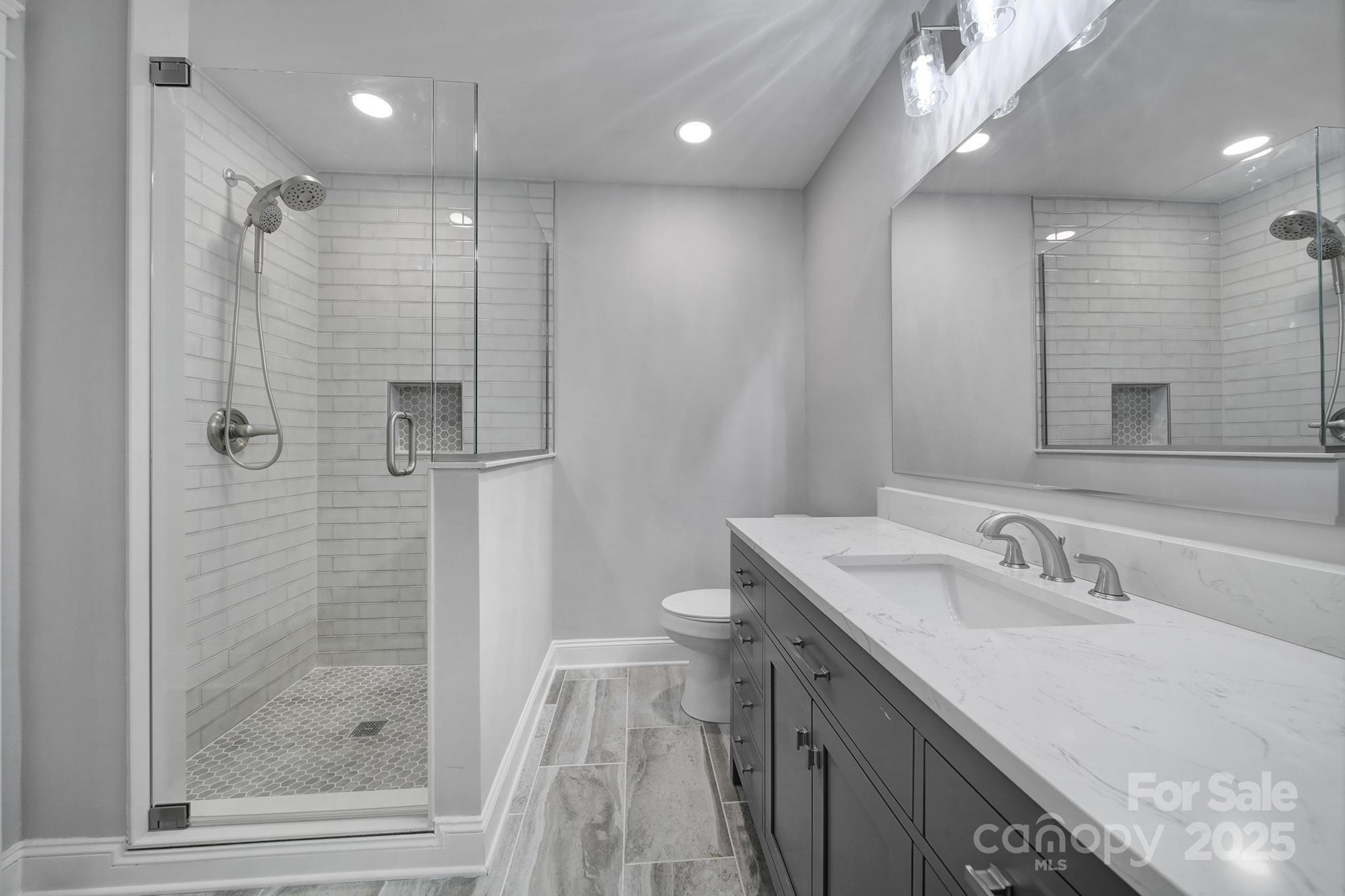 5633 Open Book Lane Charlotte, NC 28270 - Photo 24 of 48 a bathroom with a sink shower and a mirror