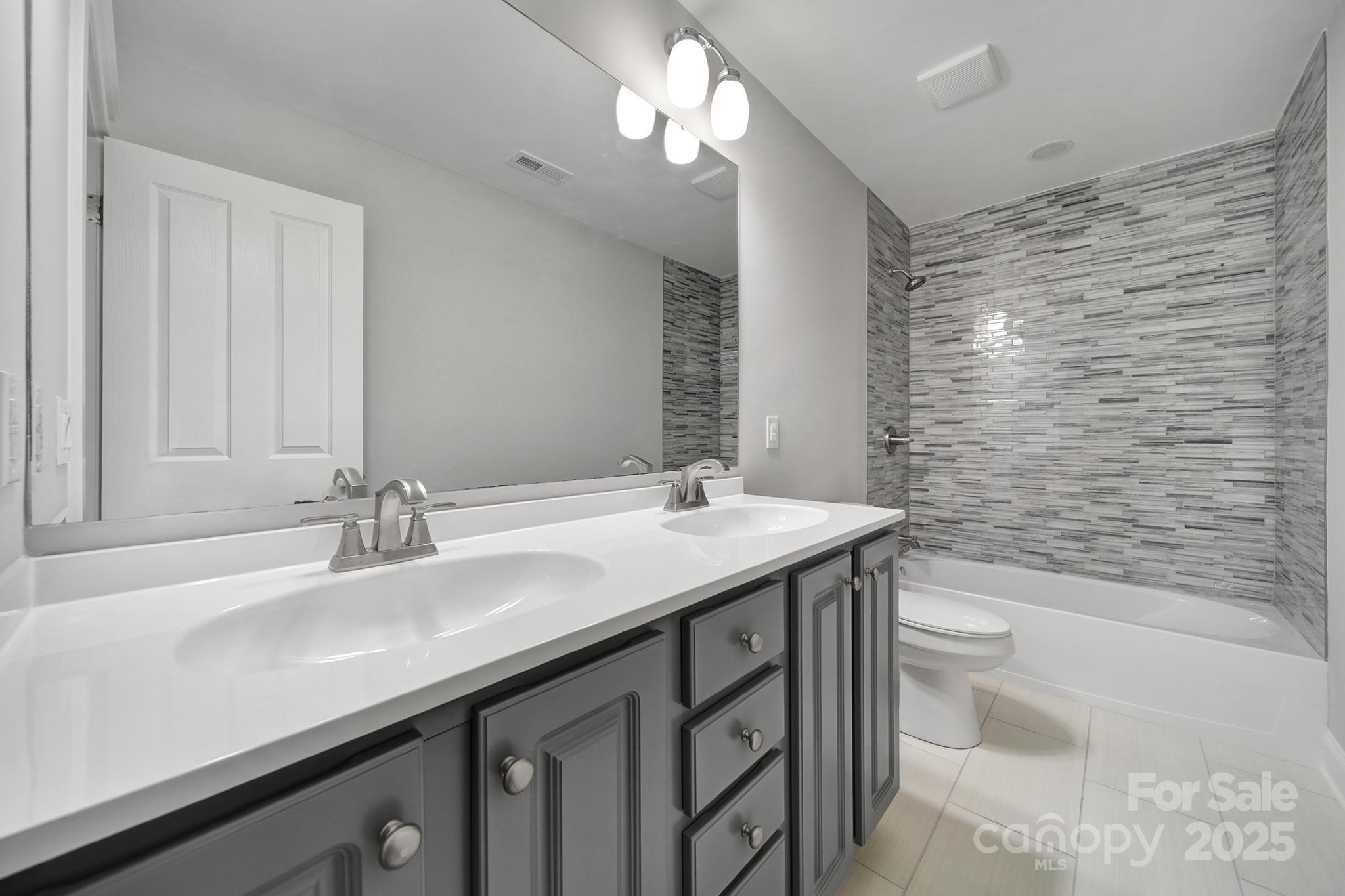 5633 Open Book Lane Charlotte, NC 28270 - Photo 32 of 48 a bathroom with a sink a toilet and shower