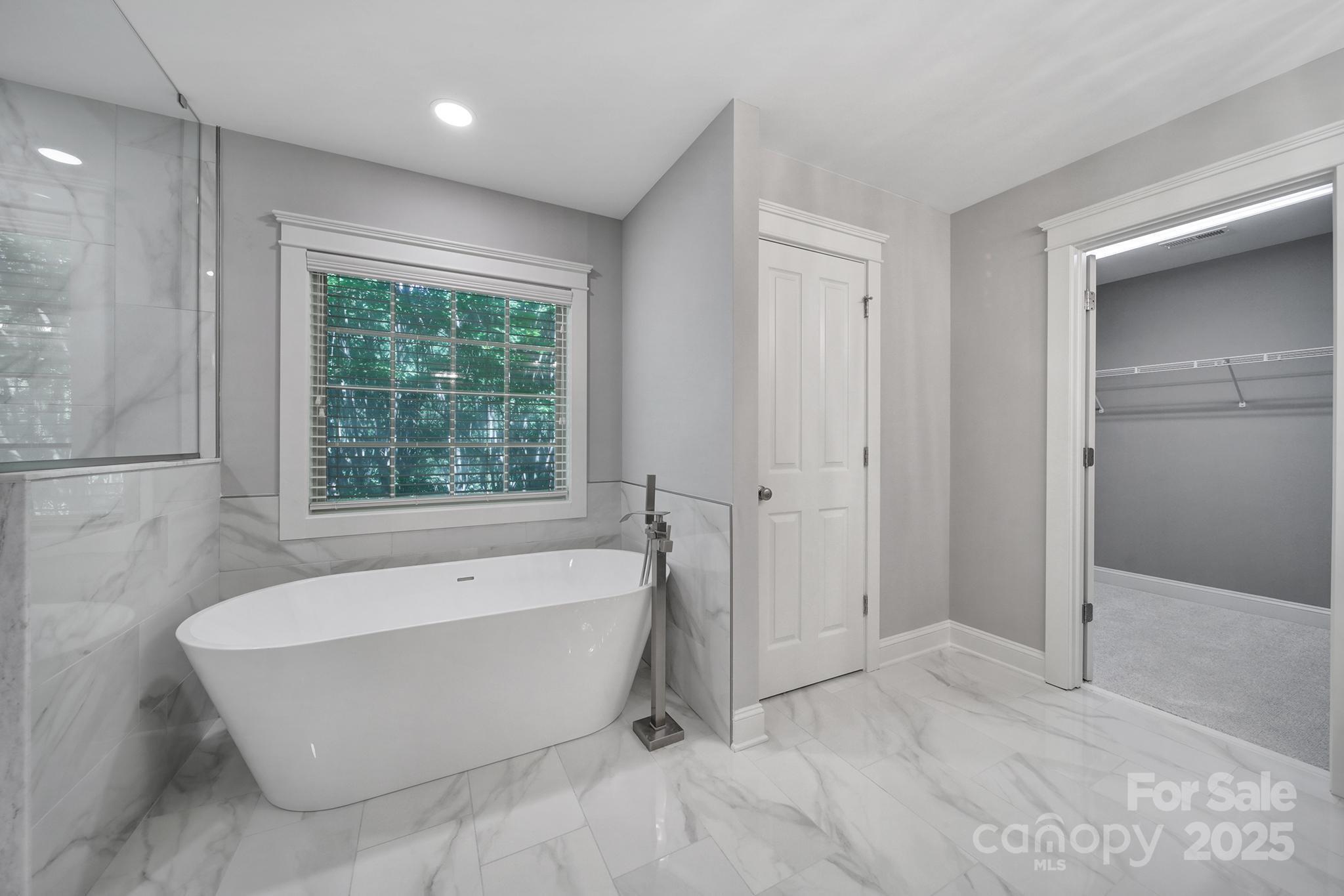 5633 Open Book Lane Charlotte, NC 28270 - Photo 36 of 48 a bathroom with a bathtub and shower