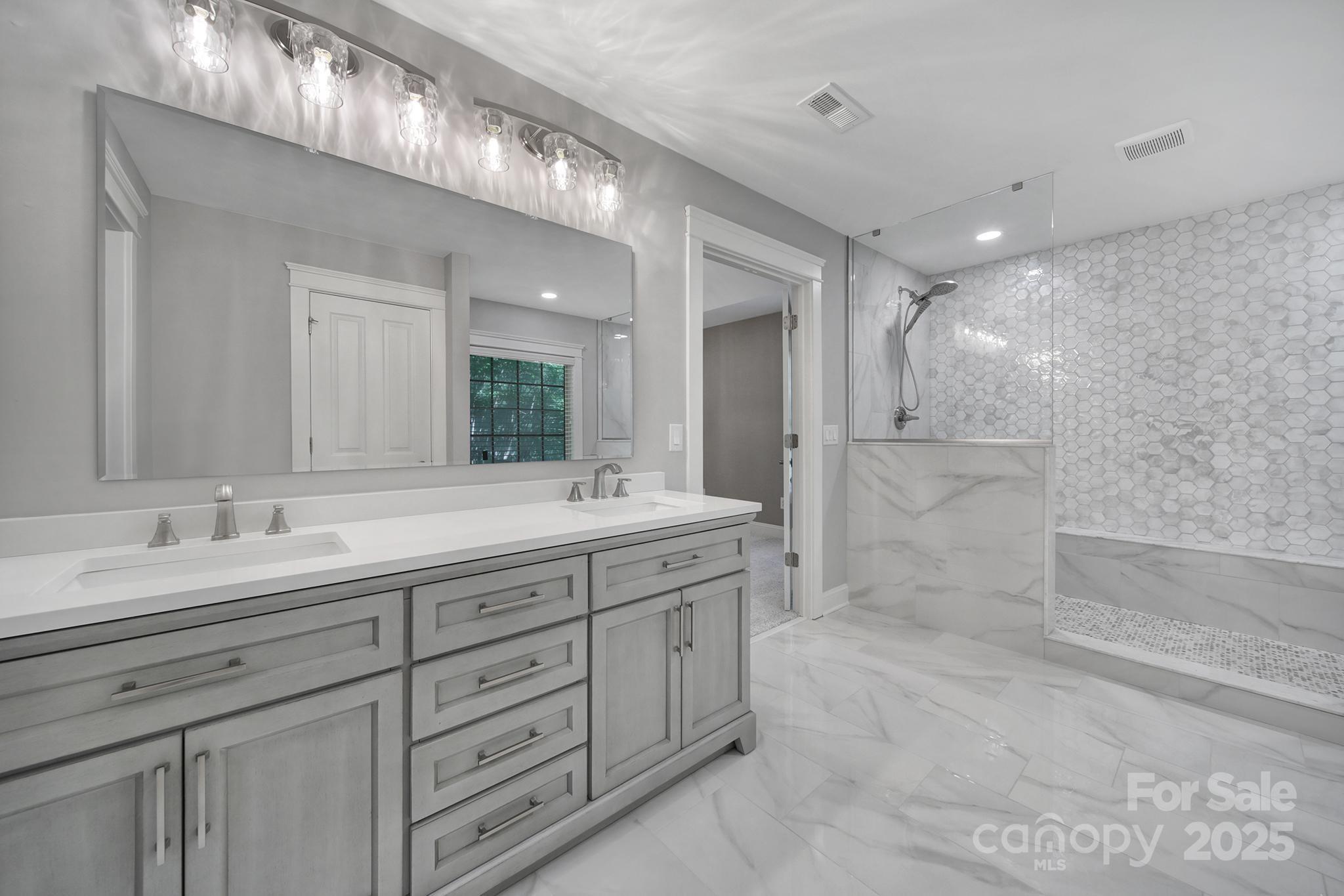 5633 Open Book Lane Charlotte, NC 28270 - Photo 38 of 48 a spacious bathroom with a double vanity sink mirror and a shower