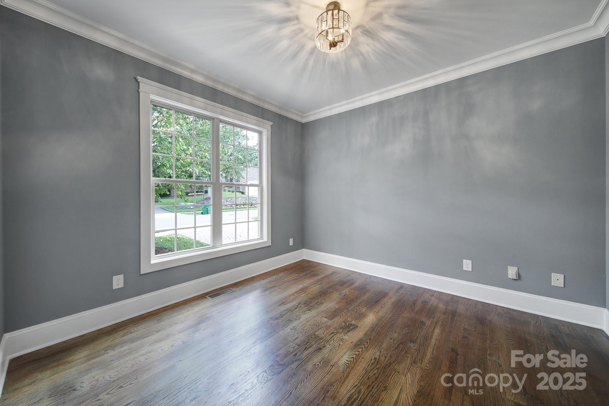 5633 Open Book Lane Charlotte, NC 28270 - Photo 41 of 48 an empty room with wooden floor fan and windows