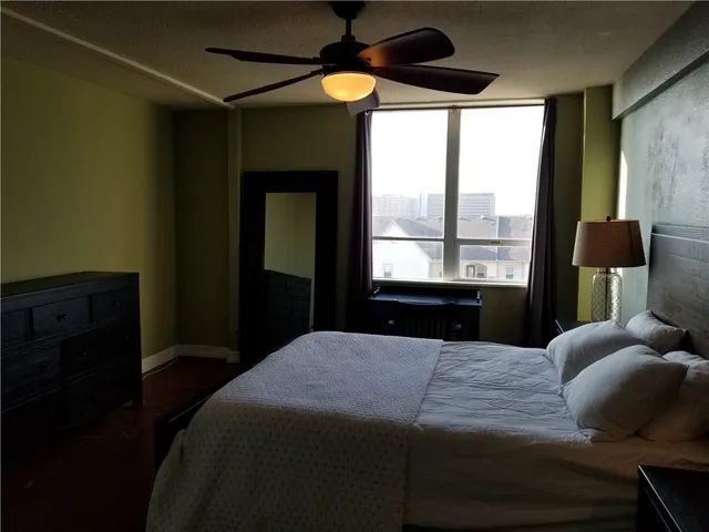 a bedroom with a bed and a window