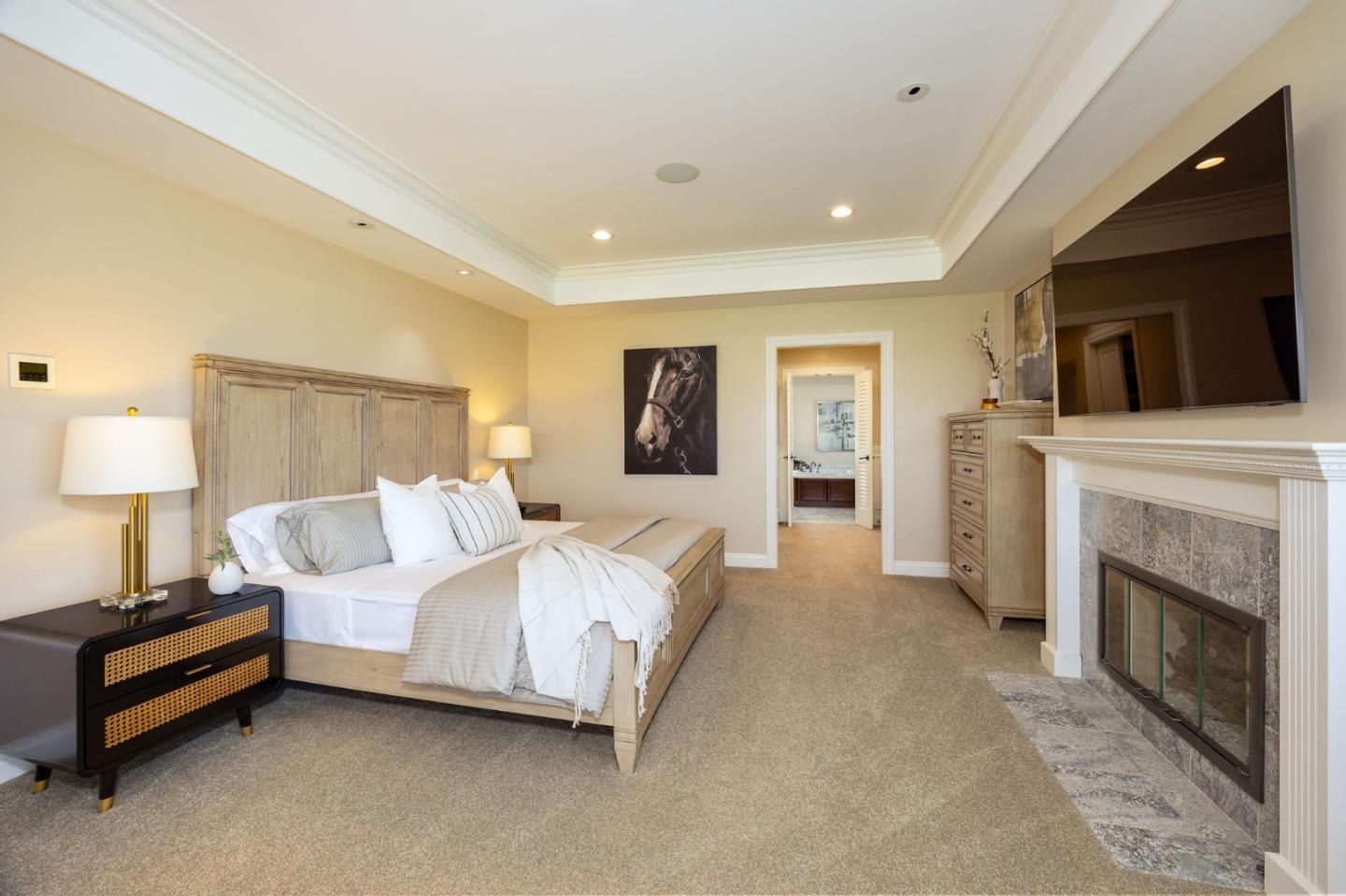 351 Cypress Point Road Half Moon Bay, CA 94019 - Photo 21 of 39 a spacious bedroom with a bed and a fireplace