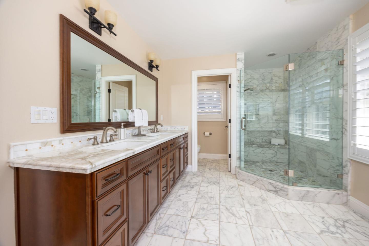 351 Cypress Point Road Half Moon Bay, CA 94019 - Photo 23 of 39 a bathroom with a granite countertop sink mirror and shower
