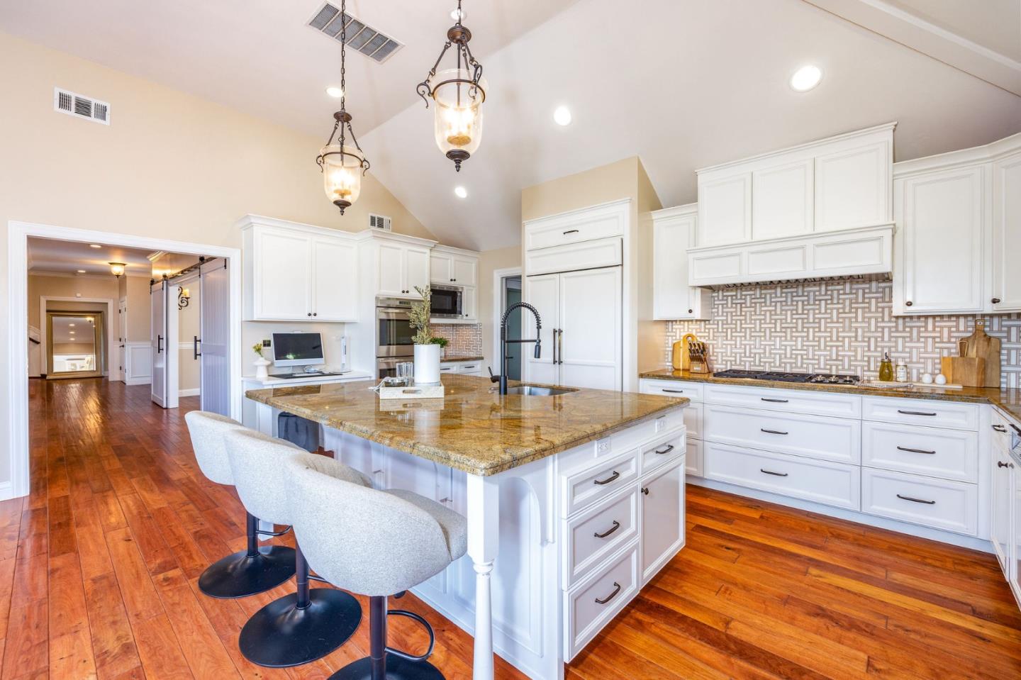 351 Cypress Point Road Half Moon Bay, CA 94019 - Photo 3 of 39 a large kitchen with kitchen island a stove a sink a center island and wooden floor