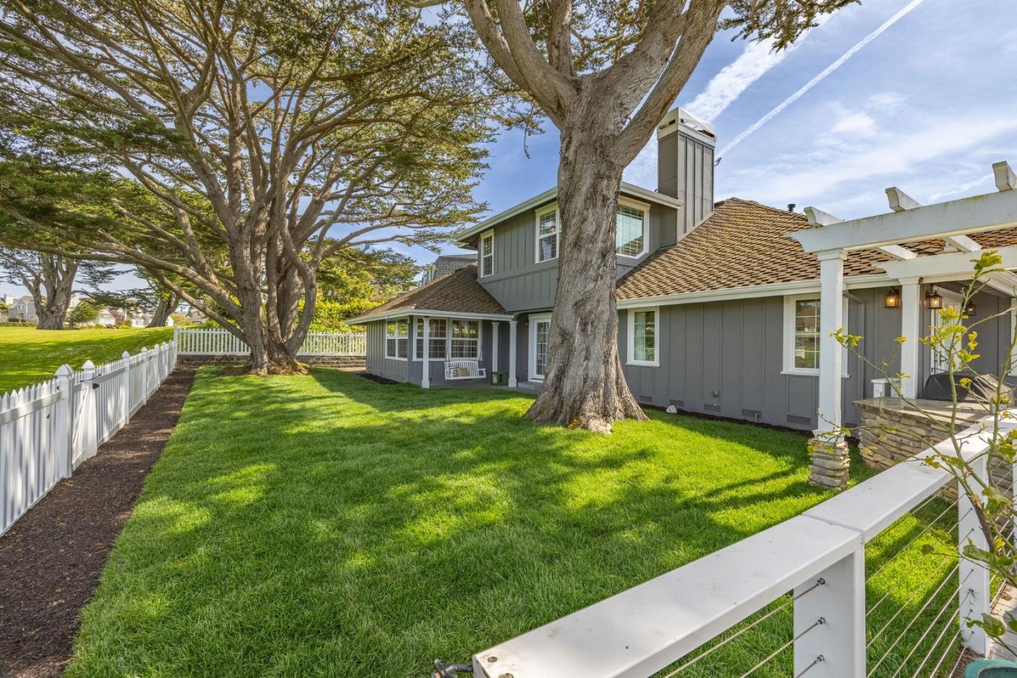 351 Cypress Point Road Half Moon Bay, CA 94019 - Photo 34 of 39 a view of a house with a yard and a tree