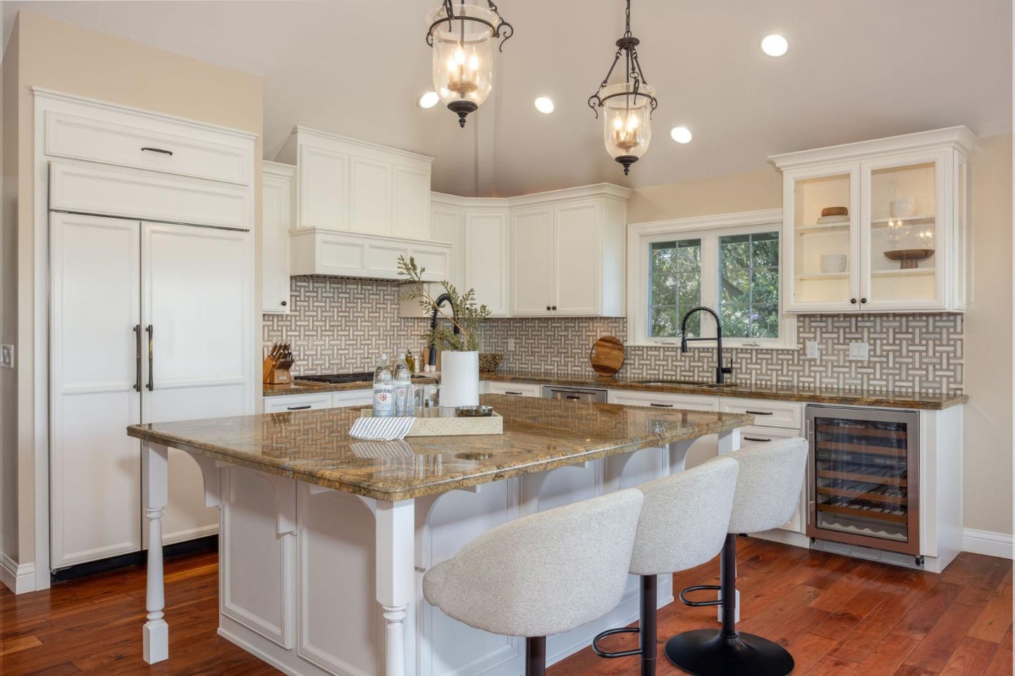 351 Cypress Point Road Half Moon Bay, CA 94019 - Photo 4 of 39 a kitchen with kitchen island granite countertop a sink cabinets and wooden floor