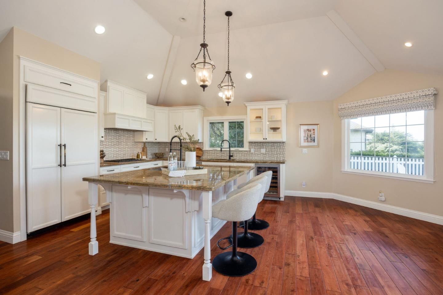 351 Cypress Point Road Half Moon Bay, CA 94019 - Photo 6 of 39 a kitchen with stainless steel appliances a dining table chairs stove and wooden floor