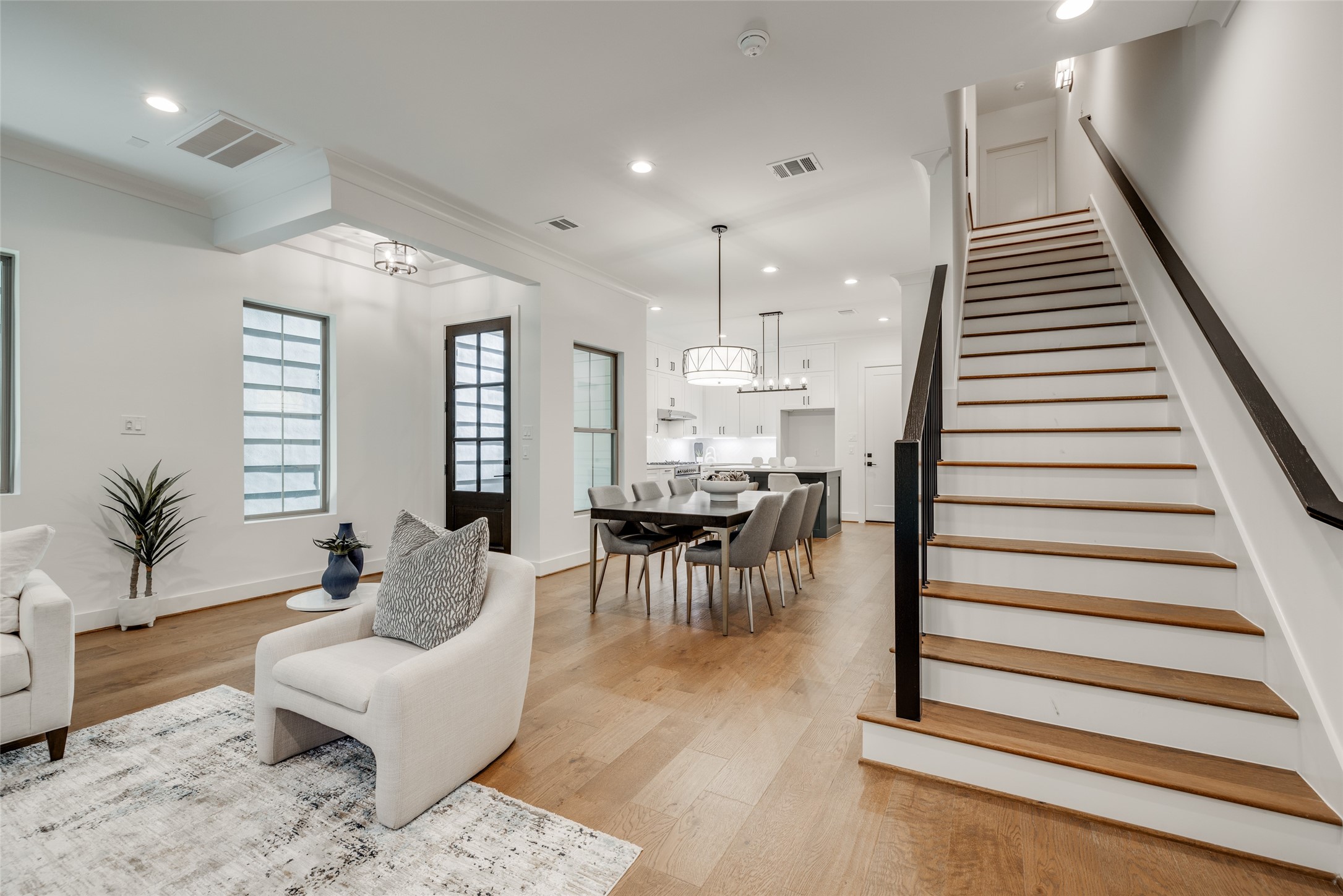 2325 Richton Street Houston, TX 77098 - Photo 25 of 47 a living room with furniture and a dining table with wooden floor