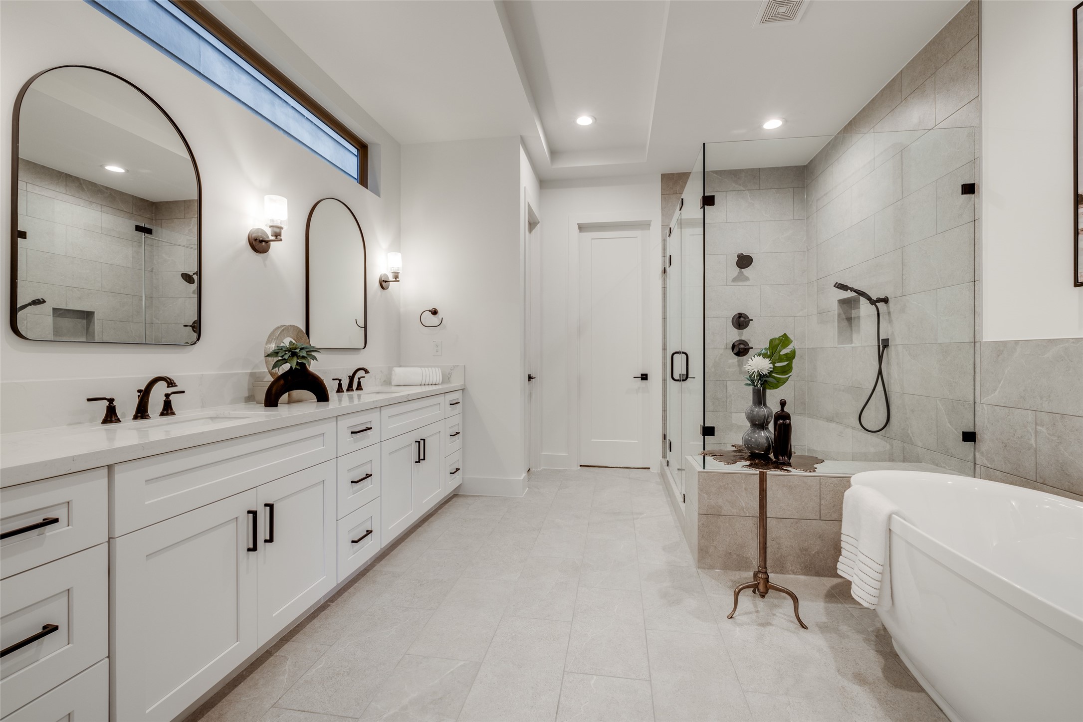2325 Richton Street Houston, TX 77098 - Photo 27 of 47 a bathroom with a double vanity sink a toilet a glass door a shower and mirror