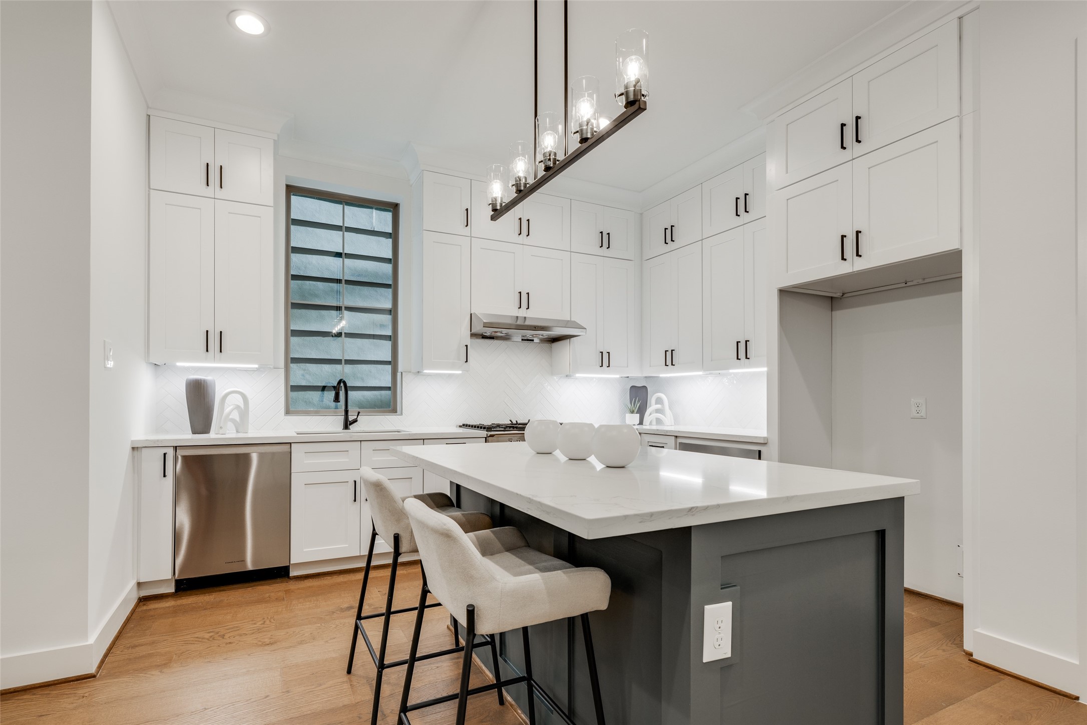 2325 Richton Street Houston, TX 77098 - Photo 10 of 47 a kitchen with stainless steel appliances a table chairs and a refrigerator