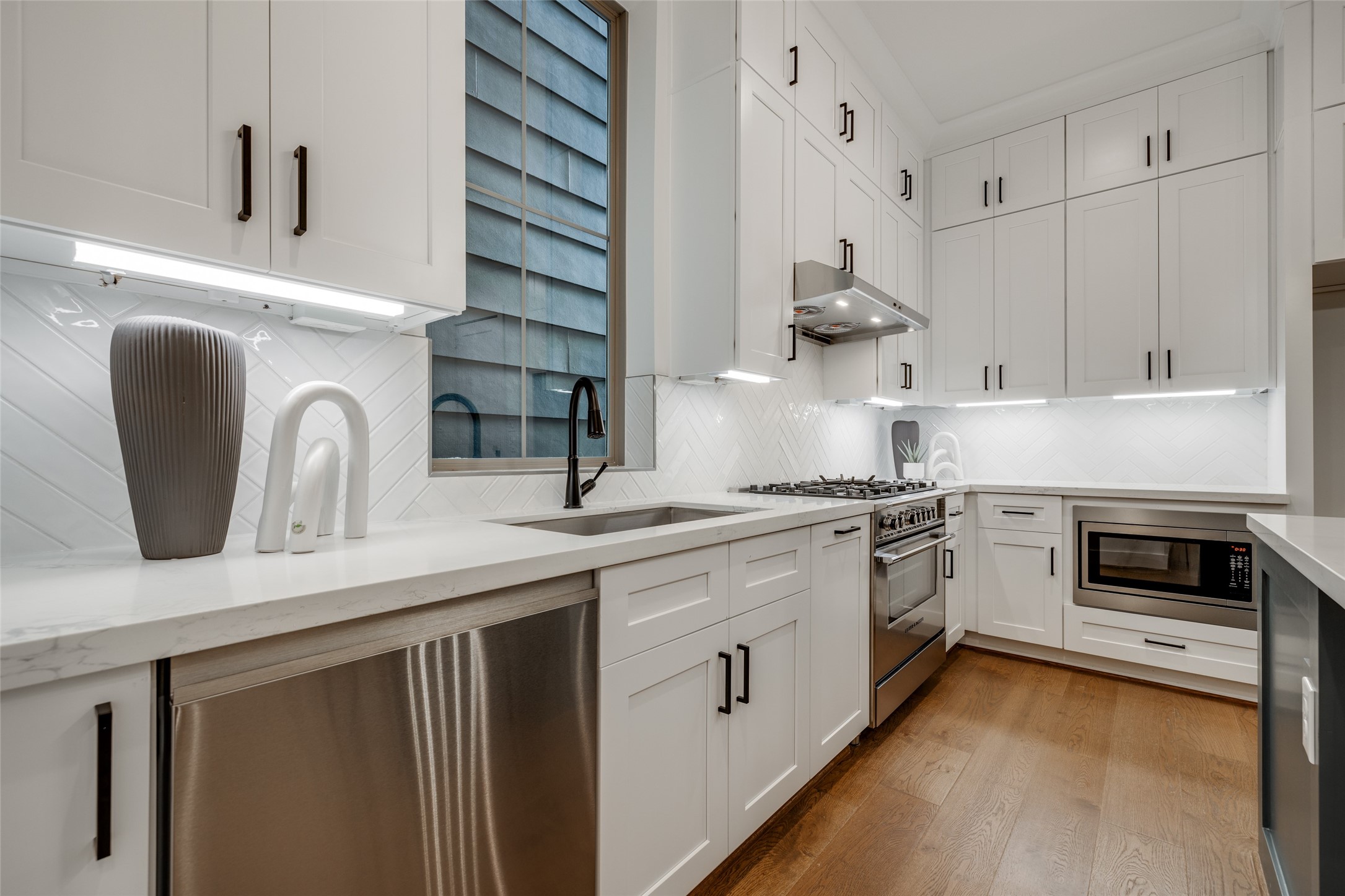 2325 Richton Street Houston, TX 77098 - Photo 12 of 47 a kitchen with stainless steel appliances white cabinets and a stove