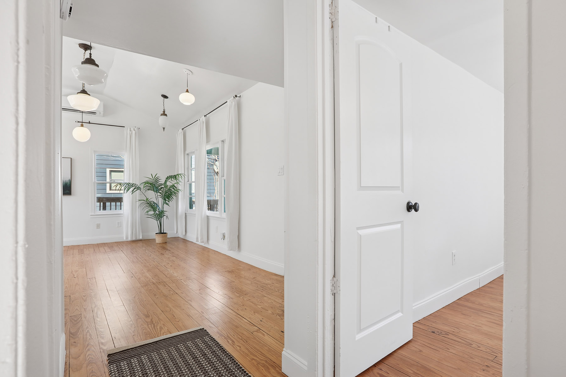 5603 Harold Court Austin, TX 78721 - Photo 15 of 31 a view of a hallway with wooden floor and a living room