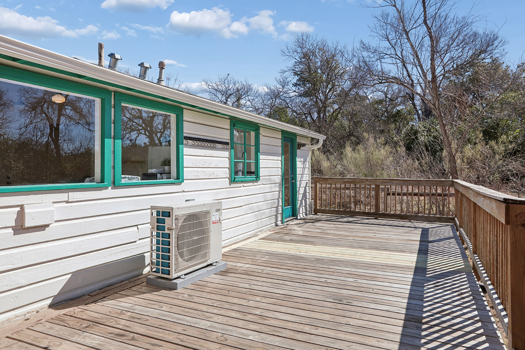 5603 Harold Court Austin, TX 78721 - Photo 17 of 31 a view of a deck with a floor to ceiling window and wooden floor