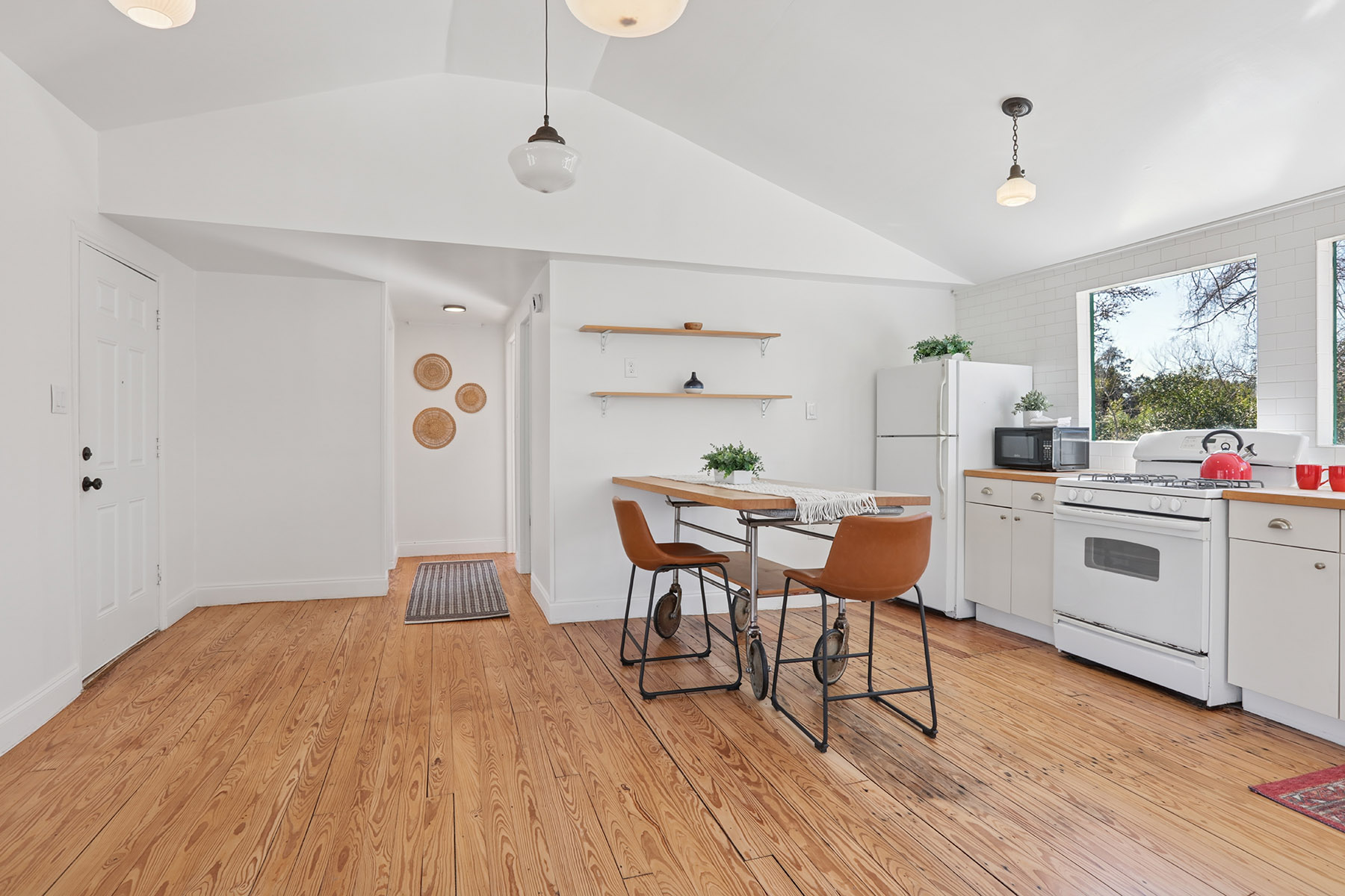5603 Harold Court Austin, TX 78721 - Photo 7 of 31 a dining room with wooden floor and white walls
