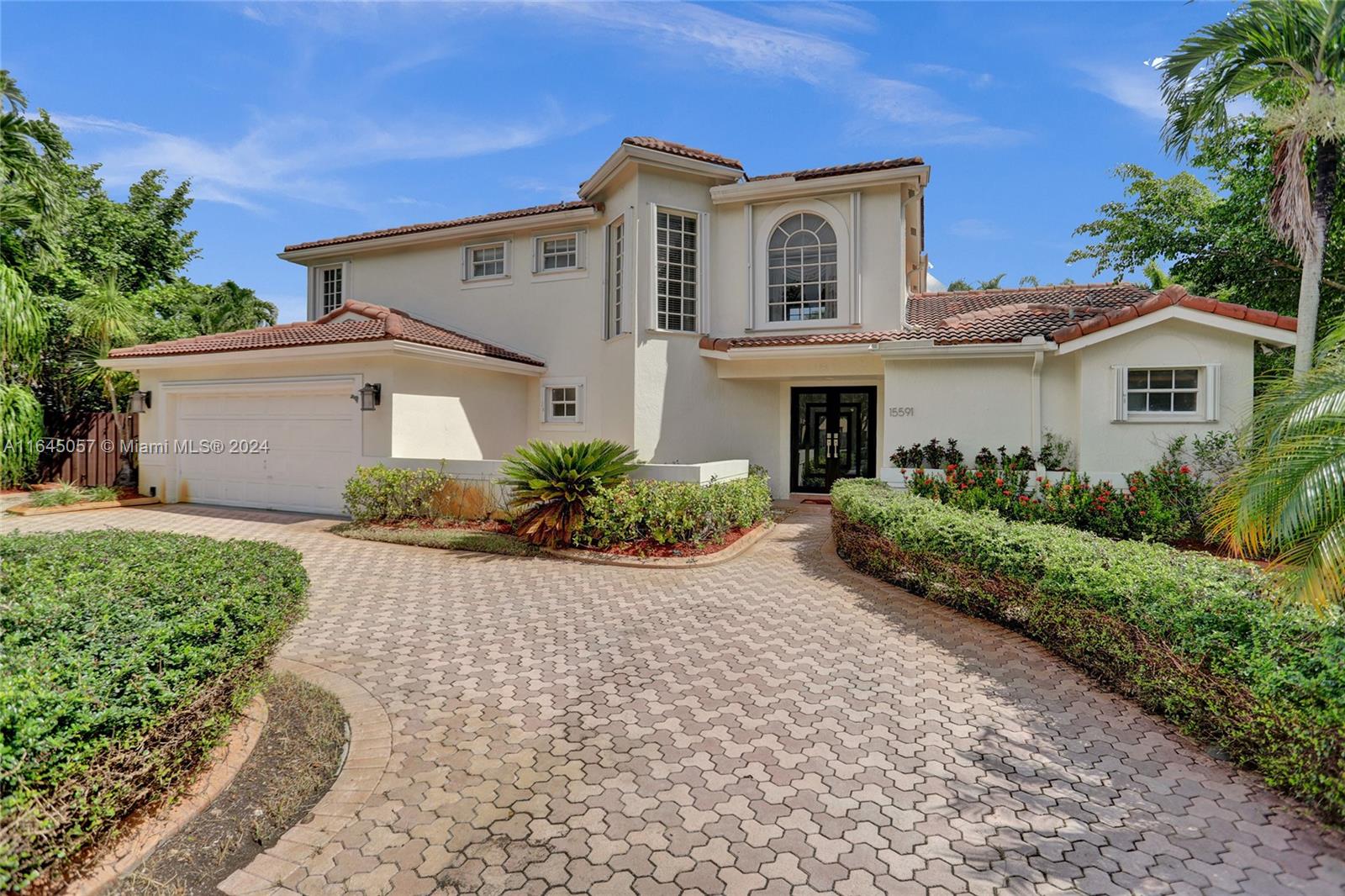 15591 Southwest 42nd Lane Miami, FL 33185 - Photo 1 of 60 a front view of a house with a yard and a garage