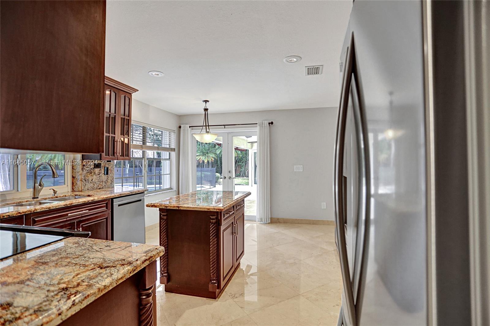 15591 Southwest 42nd Lane Miami, FL 33185 - Photo 13 of 60 a kitchen with stainless steel appliances granite countertop sink stove and refrigerator