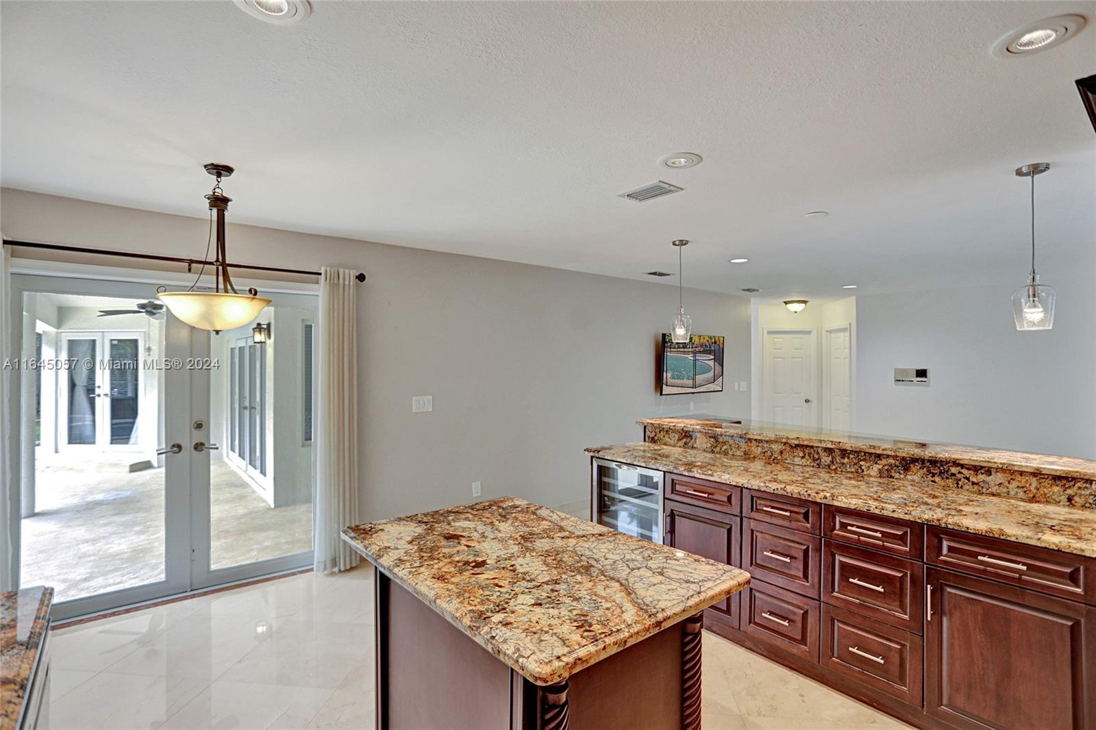 15591 Southwest 42nd Lane Miami, FL 33185 - Photo 14 of 60 a kitchen with granite countertop kitchen island a large counter top space and stainless steel appliances