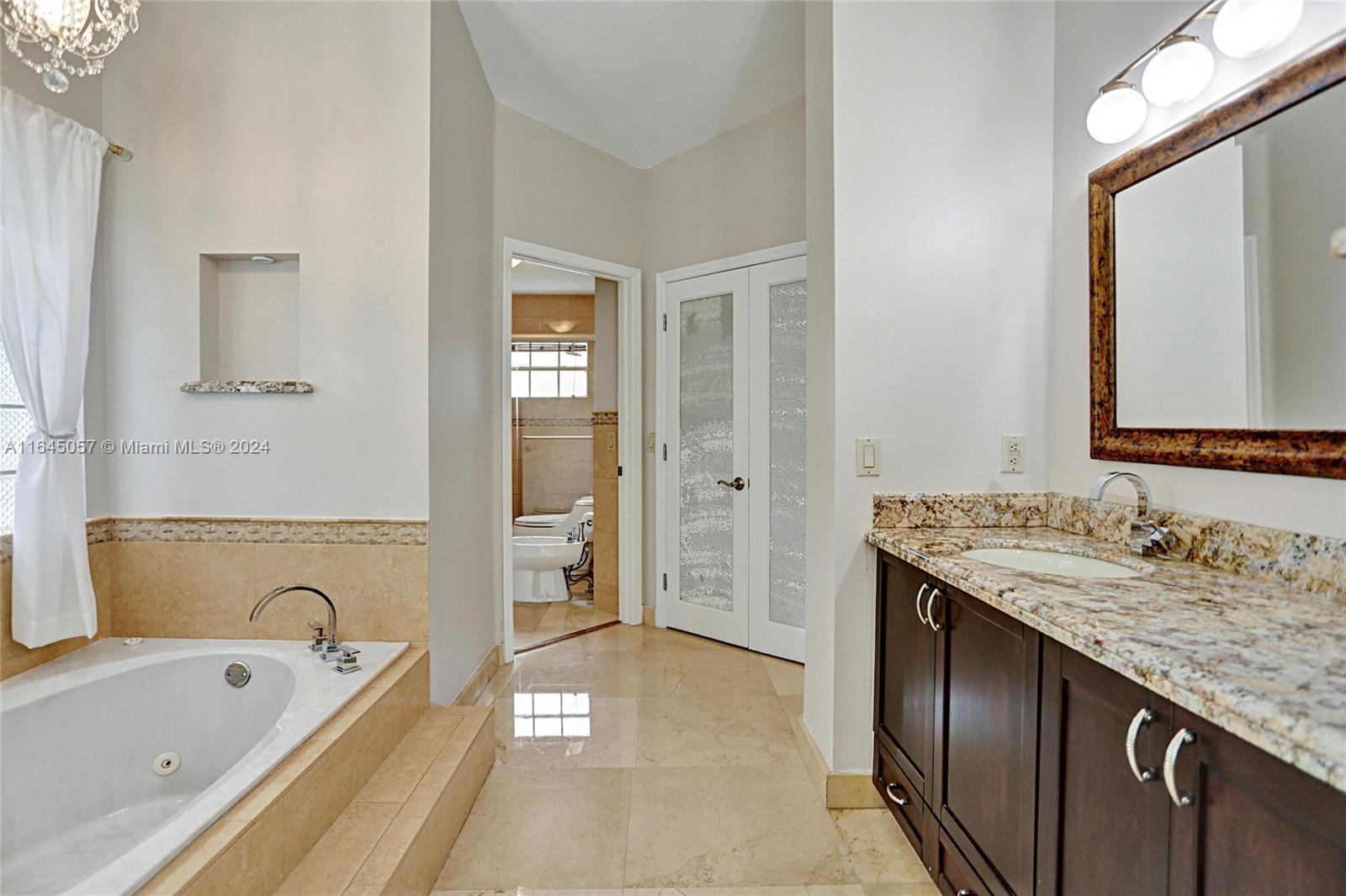 15591 Southwest 42nd Lane Miami, FL 33185 - Photo 17 of 60 a spacious bathroom with a bathtub sink and mirror