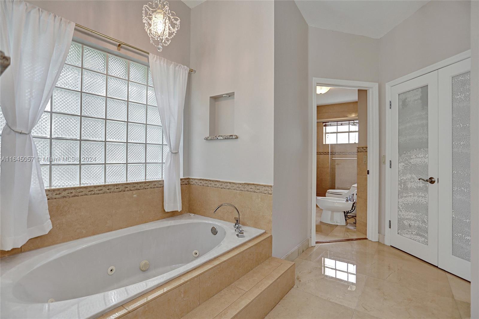 15591 Southwest 42nd Lane Miami, FL 33185 - Photo 18 of 60 a bathroom with a tub shower and sink