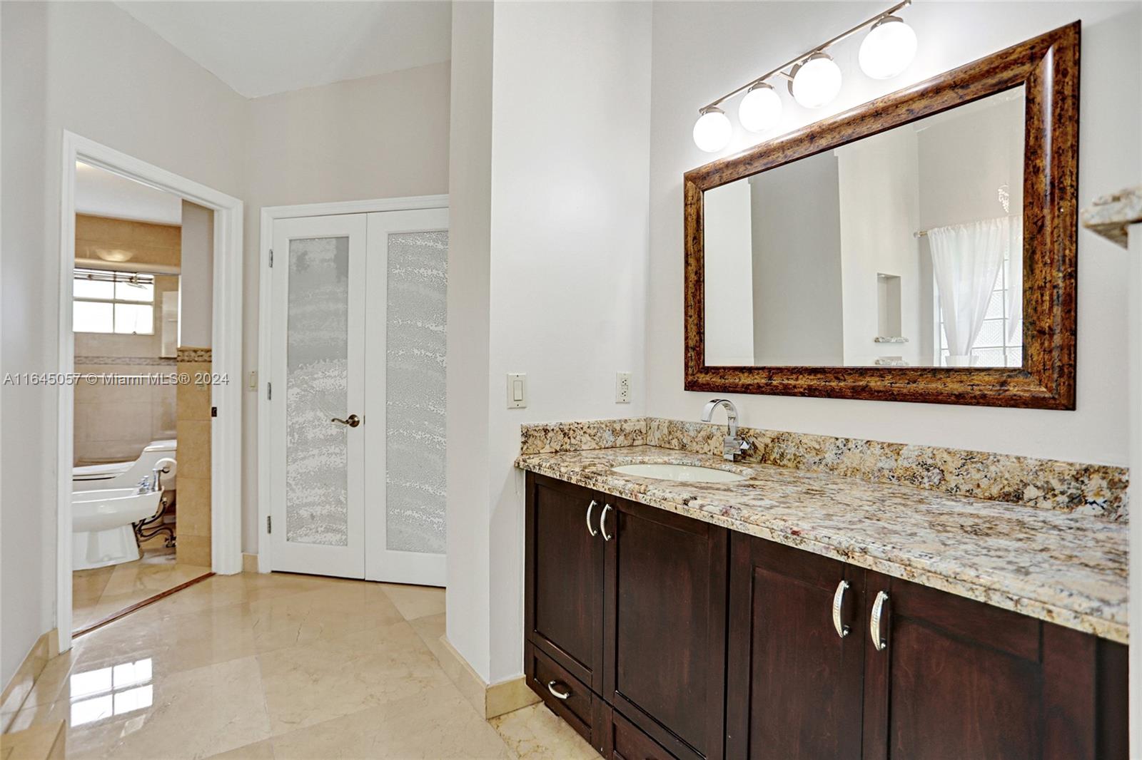 15591 Southwest 42nd Lane Miami, FL 33185 - Photo 19 of 60 a bathroom with a granite countertop sink and a mirror