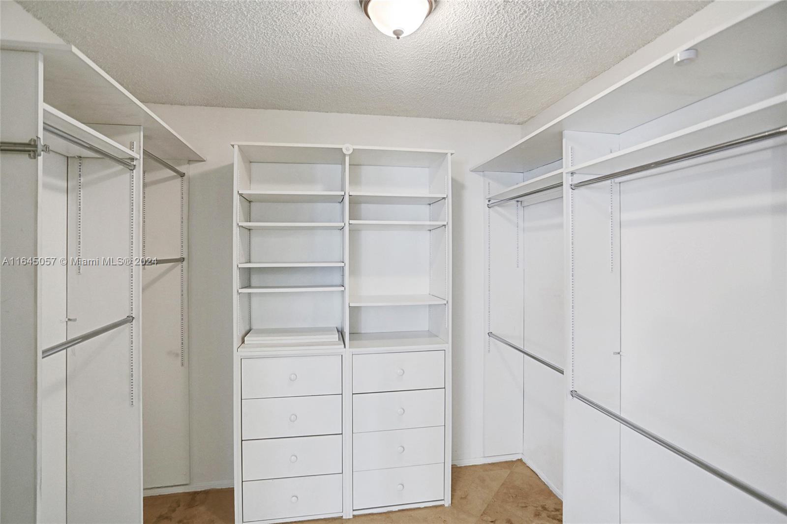 15591 Southwest 42nd Lane Miami, FL 33185 - Photo 21 of 60 a view of walk in closet with empty racks