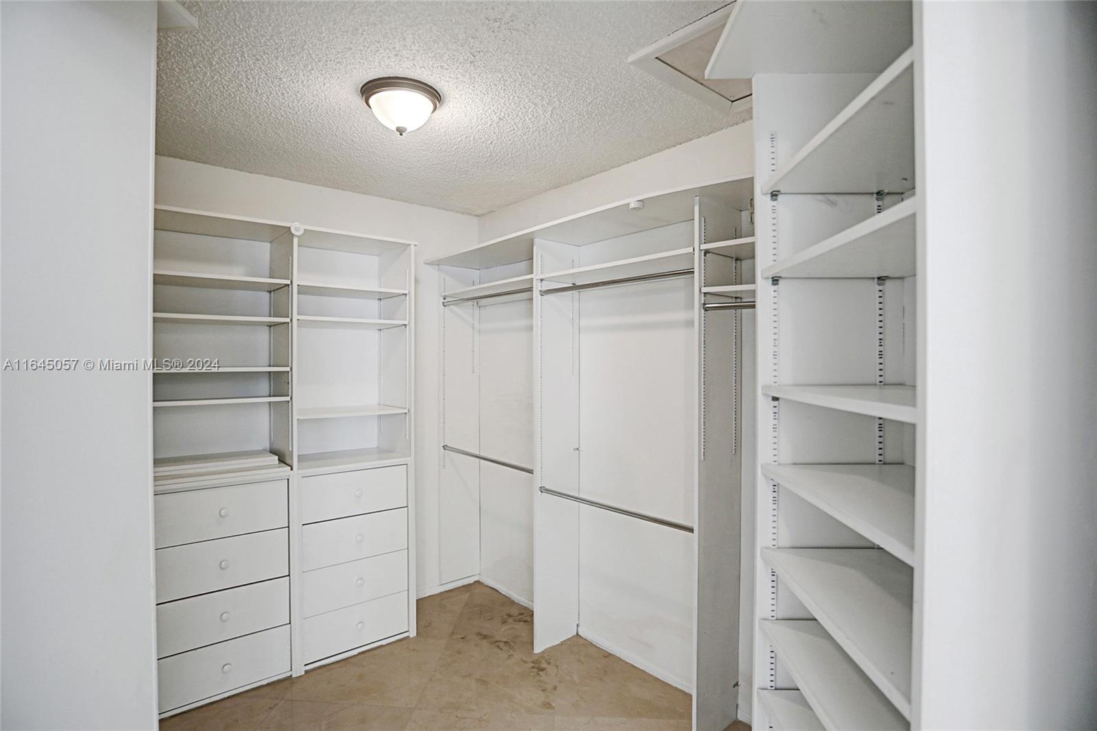 15591 Southwest 42nd Lane Miami, FL 33185 - Photo 22 of 60 a view of walk in closet with empty racks