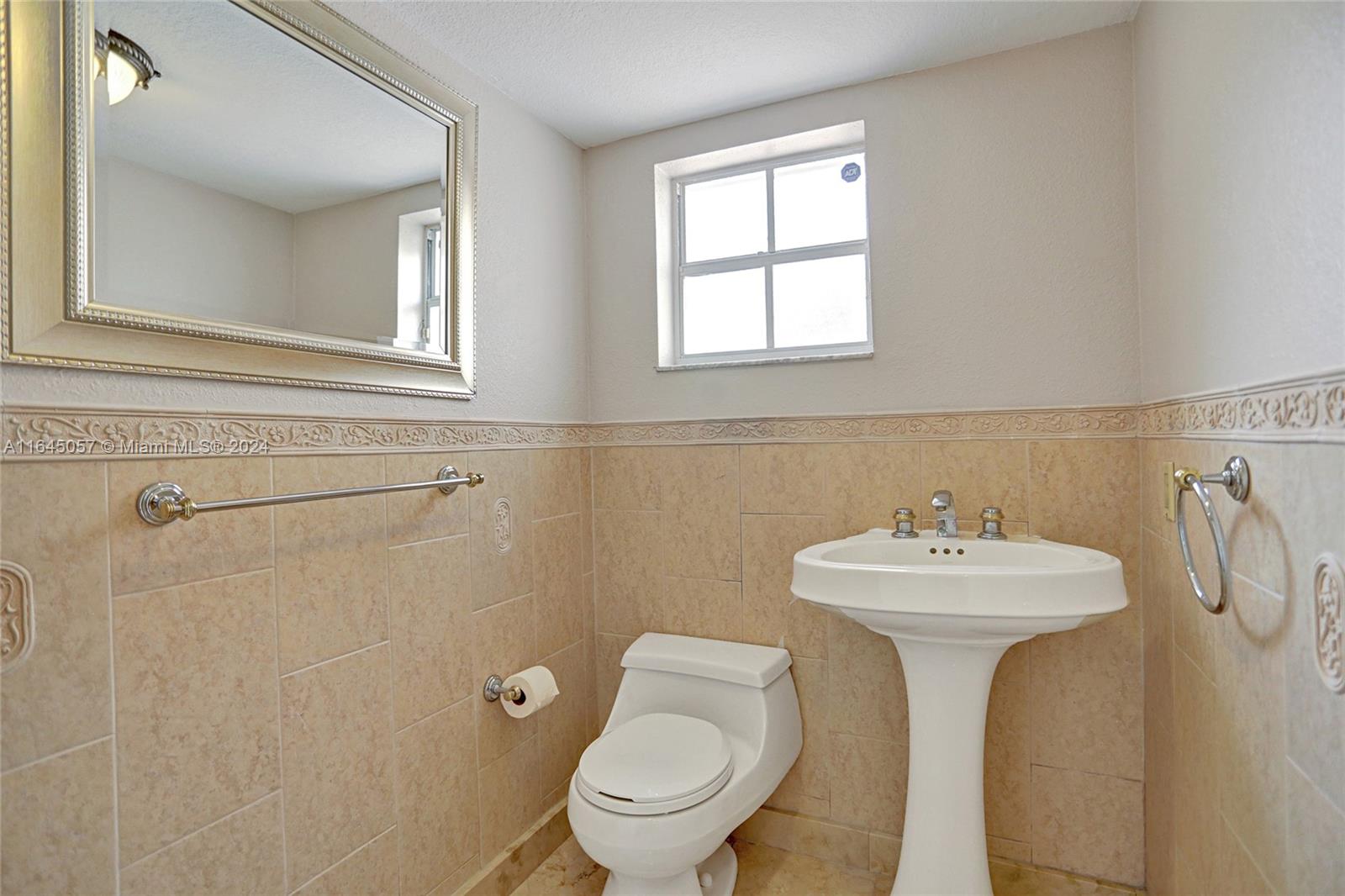 15591 Southwest 42nd Lane Miami, FL 33185 - Photo 23 of 60 a bathroom with a sink toilet and a mirror