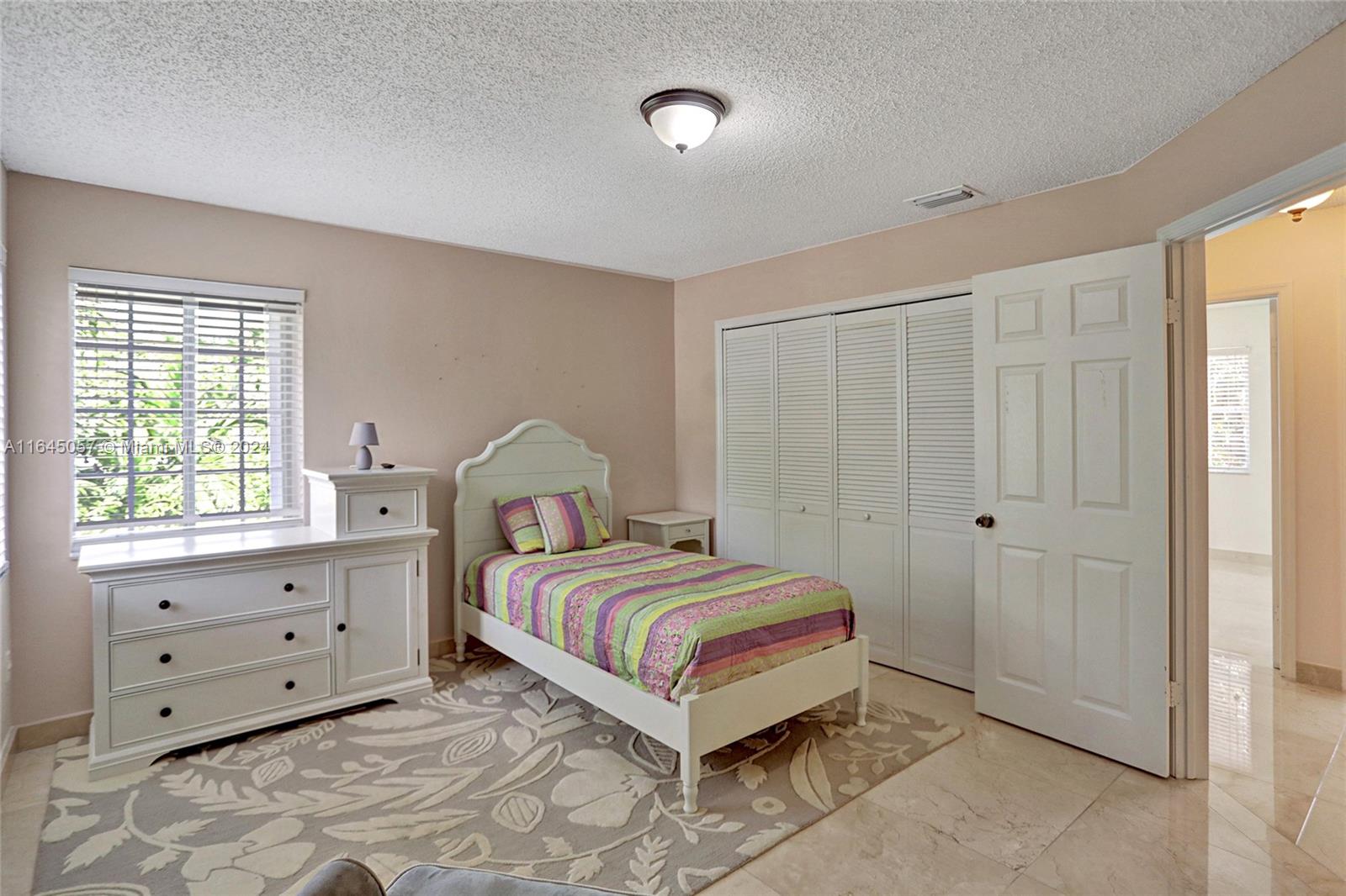 15591 Southwest 42nd Lane Miami, FL 33185 - Photo 28 of 60 a bedroom with a bed and a window