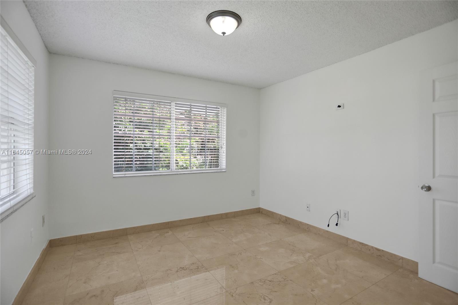 15591 Southwest 42nd Lane Miami, FL 33185 - Photo 32 of 60 an empty room with windows