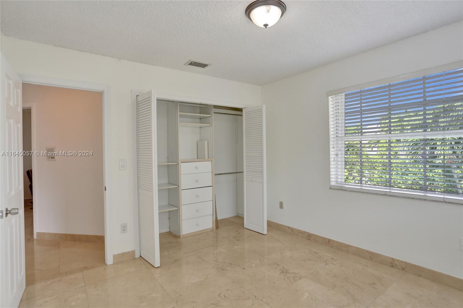 15591 Southwest 42nd Lane Miami, FL 33185 - Photo 34 of 60 an empty room with windows closet and fireplace