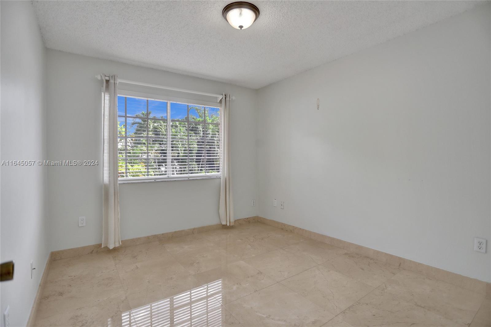 15591 Southwest 42nd Lane Miami, FL 33185 - Photo 36 of 60 an empty room with windows