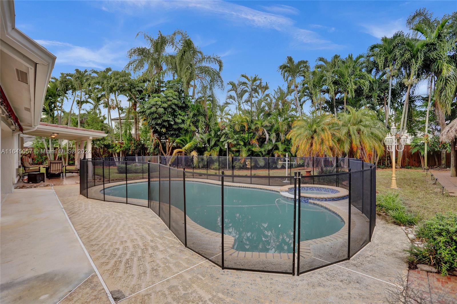 15591 Southwest 42nd Lane Miami, FL 33185 - Photo 43 of 60 a view of a swimming pool with a patio