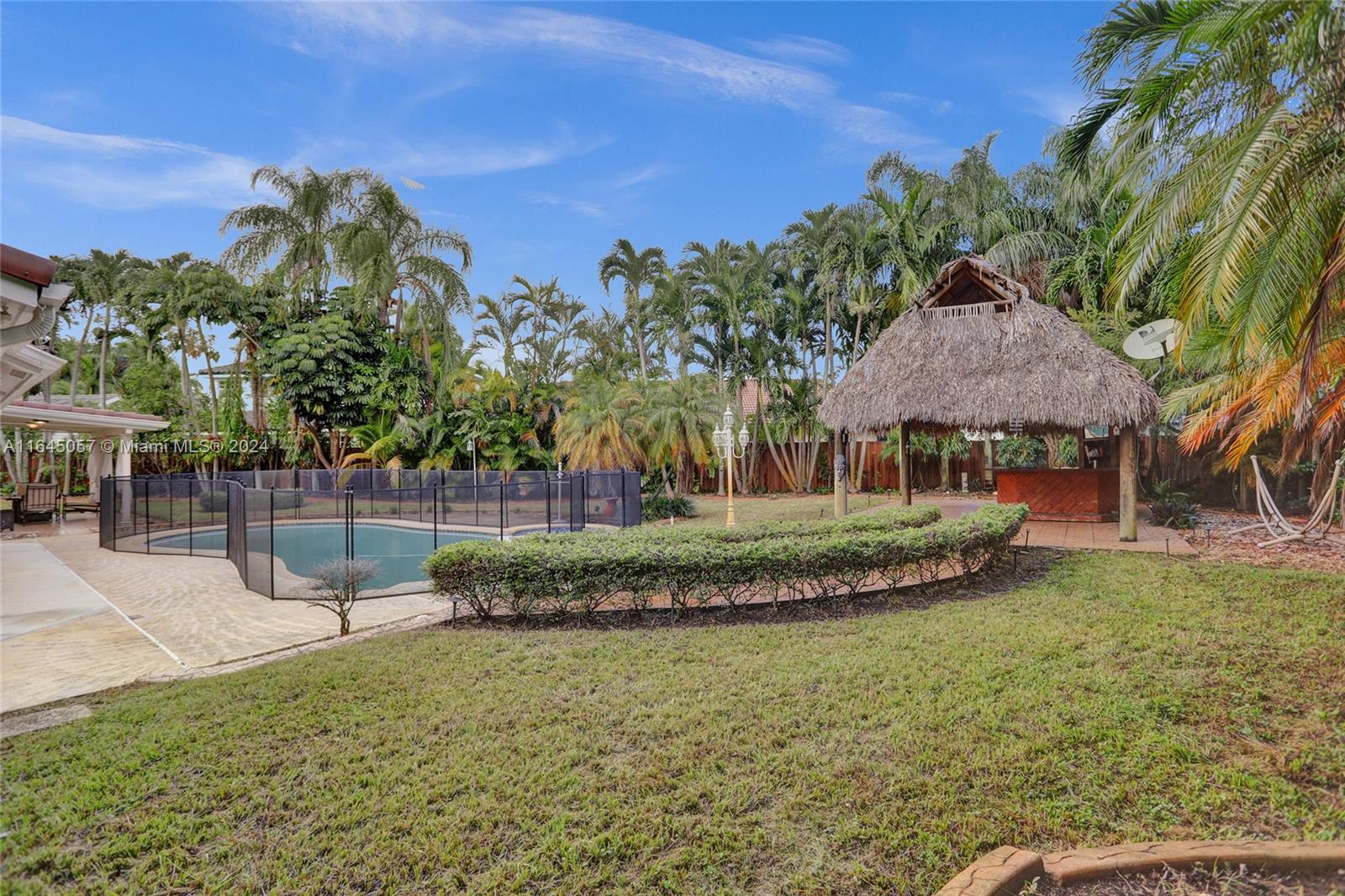 15591 Southwest 42nd Lane Miami, FL 33185 - Photo 46 of 60 a view of a house with a yard and sitting area