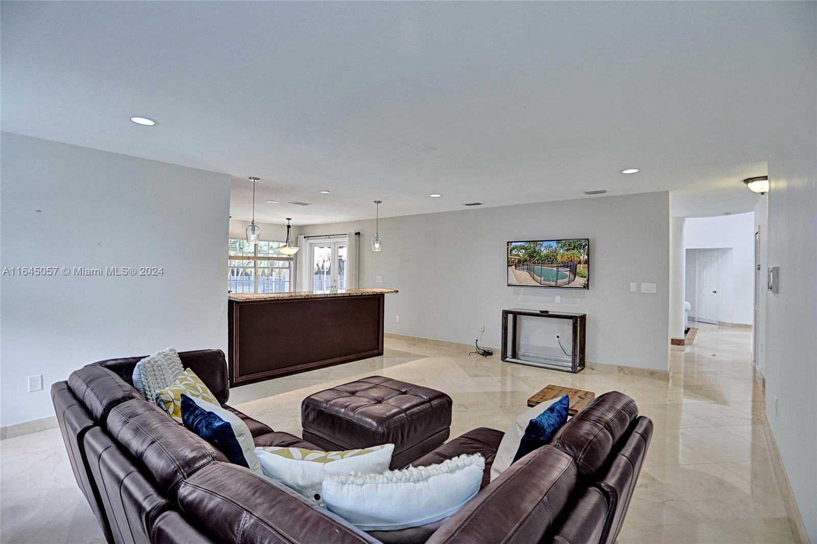 15591 Southwest 42nd Lane Miami, FL 33185 - Photo 10 of 60 a living room with furniture a flat screen tv and a window