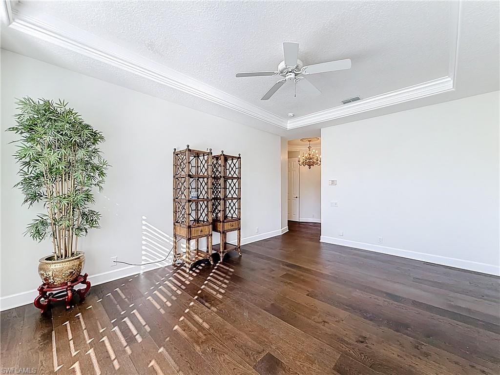 3051 Lancaster Drive, Unit 2 Naples, FL 34105 - Photo 11 of 43 a view of empty room with wooden floor and fan