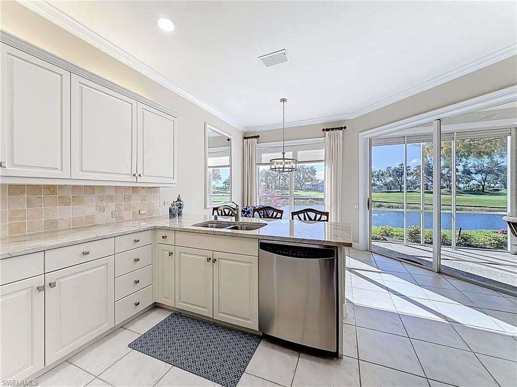 3051 Lancaster Drive, Unit 2 Naples, FL 34105 - Photo 13 of 43 a kitchen with sink and cabinets