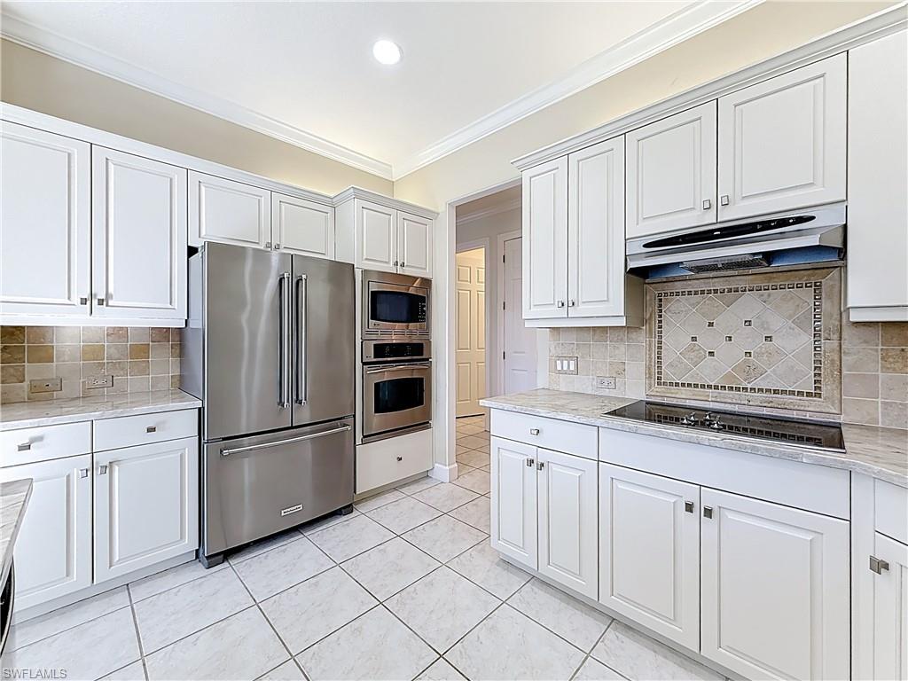 3051 Lancaster Drive, Unit 2 Naples, FL 34105 - Photo 14 of 43 a kitchen with granite countertop white cabinets and stainless steel appliances