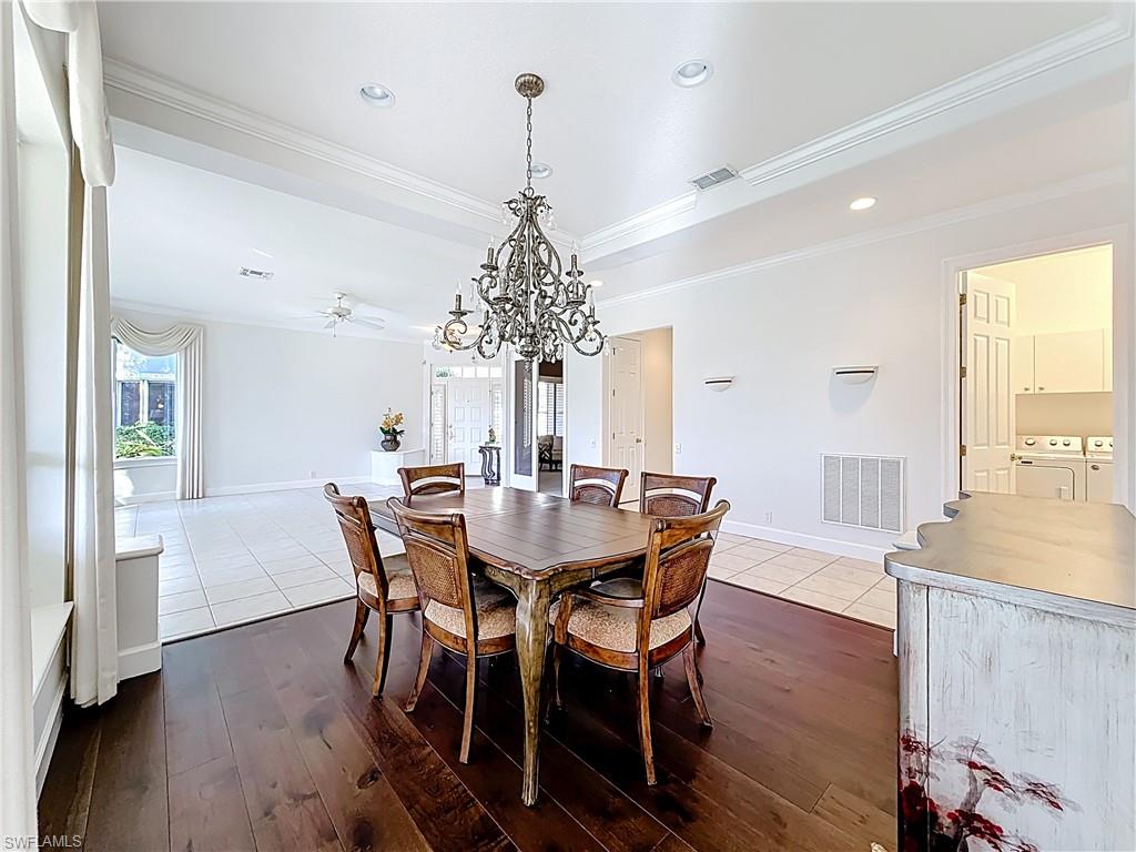 3051 Lancaster Drive, Unit 2 Naples, FL 34105 - Photo 15 of 43 a view of a dining room with furniture window and wooden floor