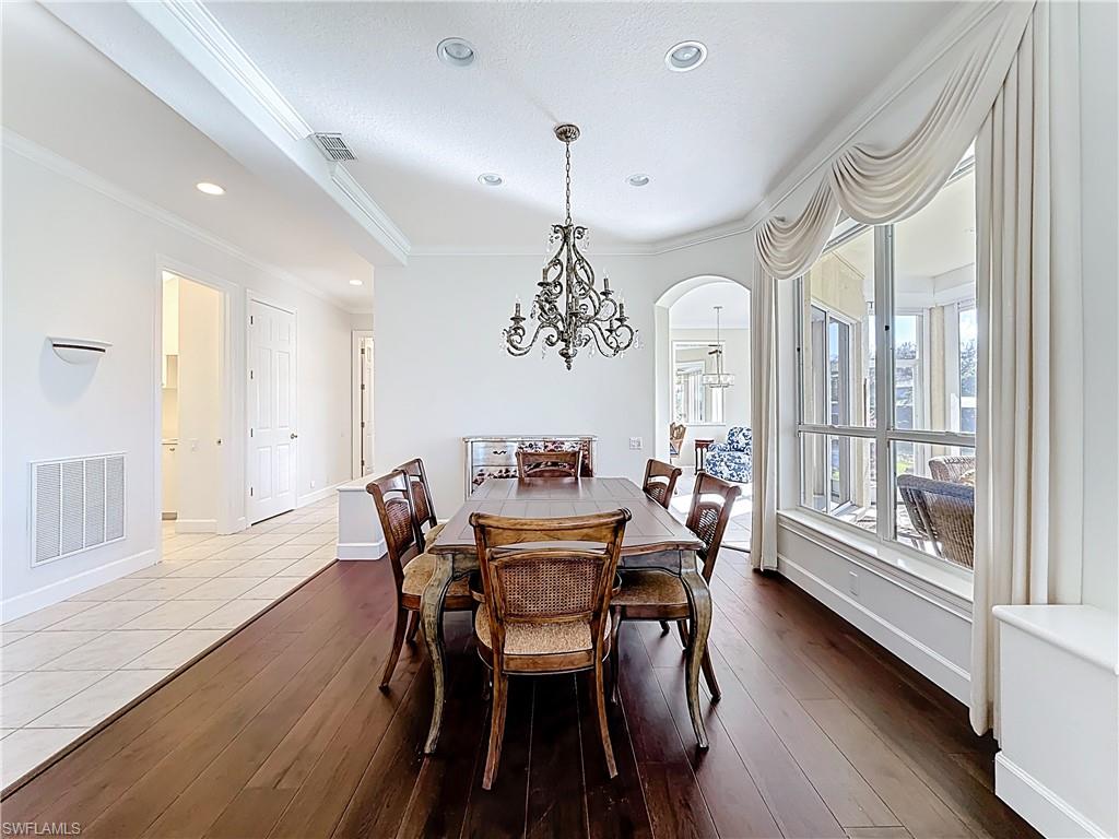 3051 Lancaster Drive, Unit 2 Naples, FL 34105 - Photo 16 of 43 a view of a dining room with furniture window and wooden floor