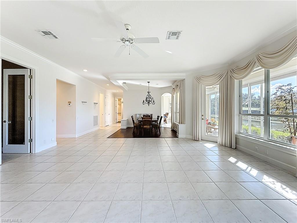 3051 Lancaster Drive, Unit 2 Naples, FL 34105 - Photo 17 of 43 a view of a big room with windows and chandelier fan