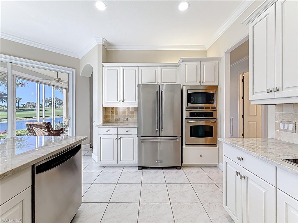 3051 Lancaster Drive, Unit 2 Naples, FL 34105 - Photo 18 of 43 a kitchen with a refrigerator a stove a sink and a counter space