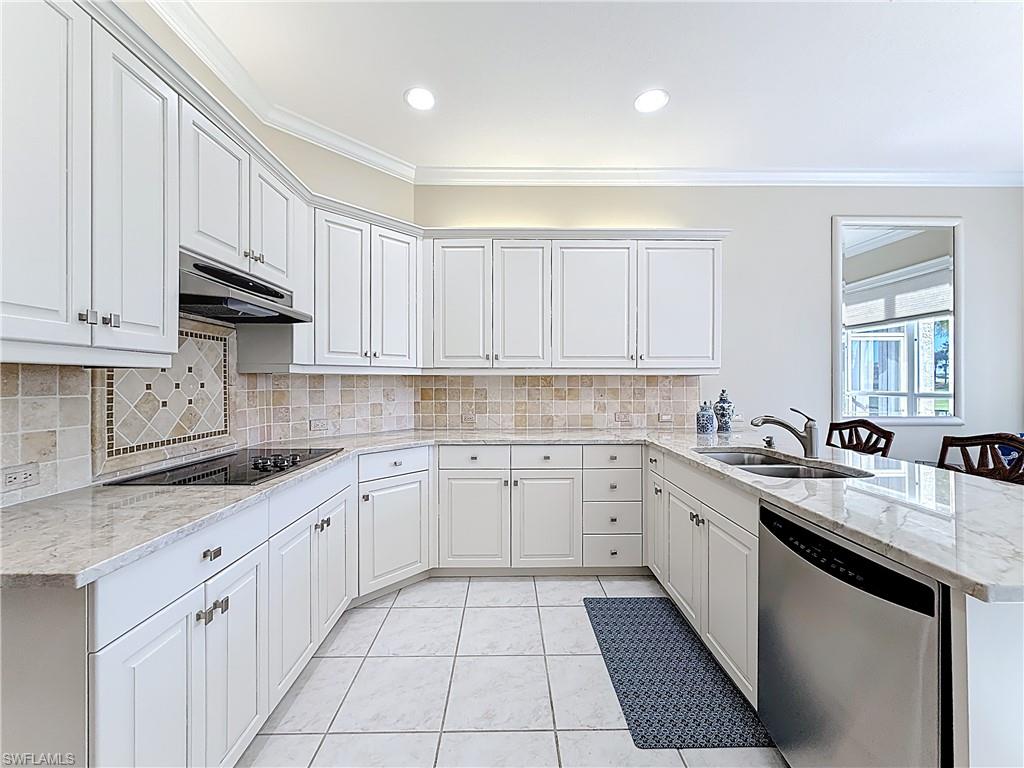 3051 Lancaster Drive, Unit 2 Naples, FL 34105 - Photo 21 of 43 a kitchen with a sink dishwasher and cabinets