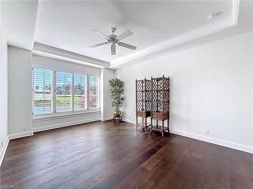 3051 Lancaster Drive, Unit 2 Naples, FL 34105 - Photo 23 of 43 an empty room with wooden floor fan and windows