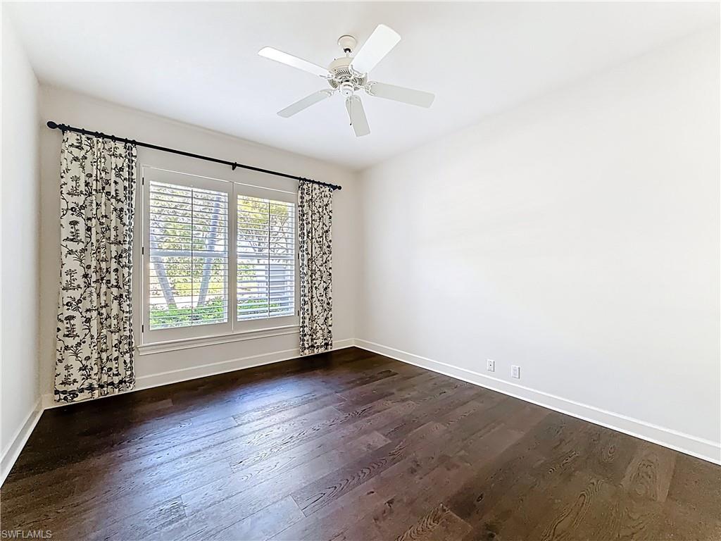 3051 Lancaster Drive, Unit 2 Naples, FL 34105 - Photo 28 of 43 an empty room with wooden floor fan and windows