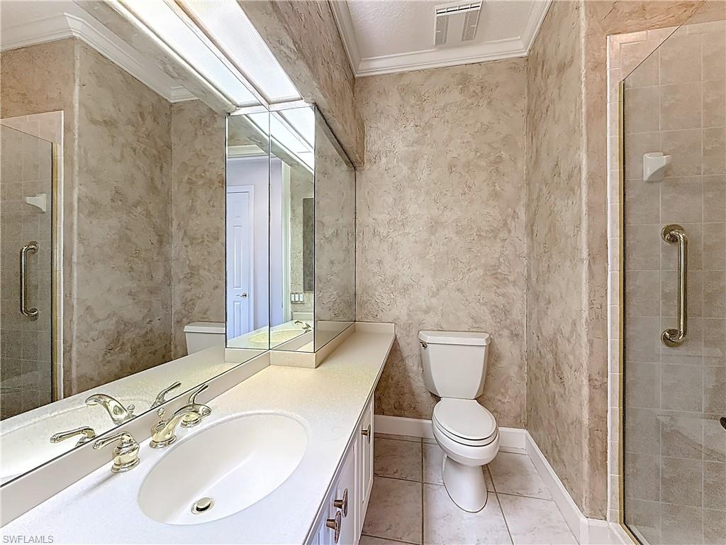 3051 Lancaster Drive, Unit 2 Naples, FL 34105 - Photo 31 of 43 a bathroom with a toilet a sink and shower