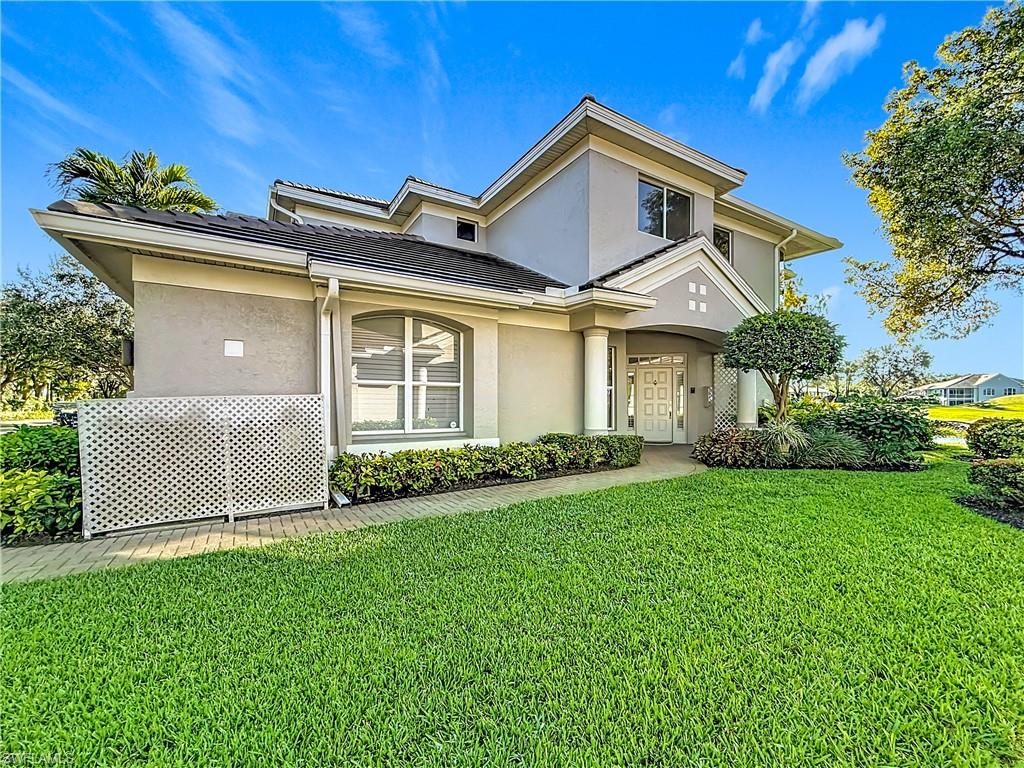3051 Lancaster Drive, Unit 2 Naples, FL 34105 - Photo 34 of 43 a front view of a house with a garden