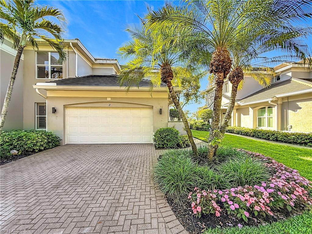 3051 Lancaster Drive, Unit 2 Naples, FL 34105 - Photo 35 of 43 a front view of a house with a yard and garage