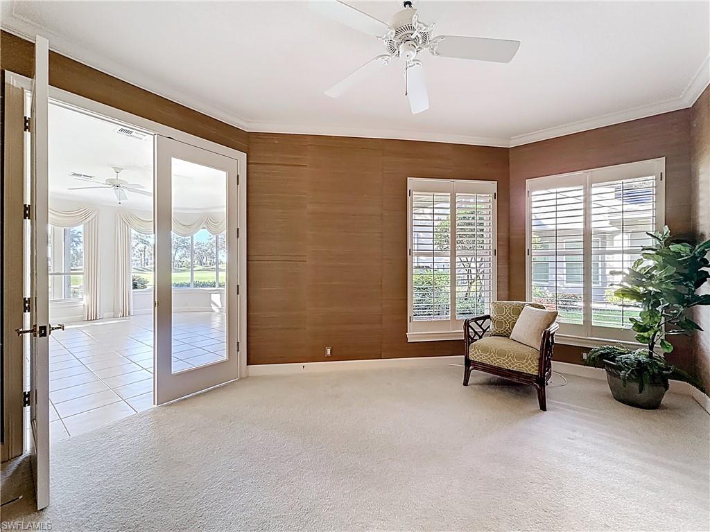 3051 Lancaster Drive, Unit 2 Naples, FL 34105 - Photo 6 of 43 a living room with furniture and a floor to ceiling window